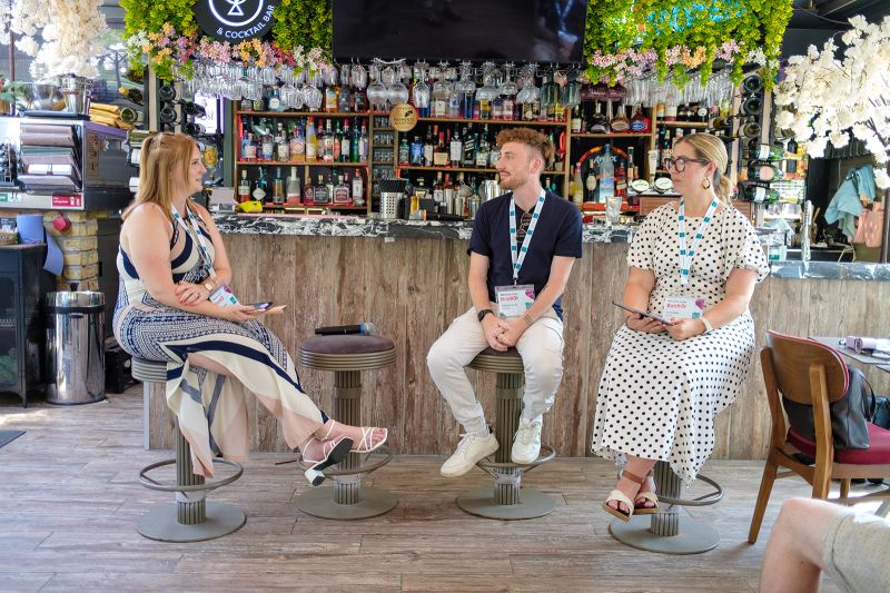 Lorna, in a polka dot dress, on a panel at the Silvercloud BobBQ